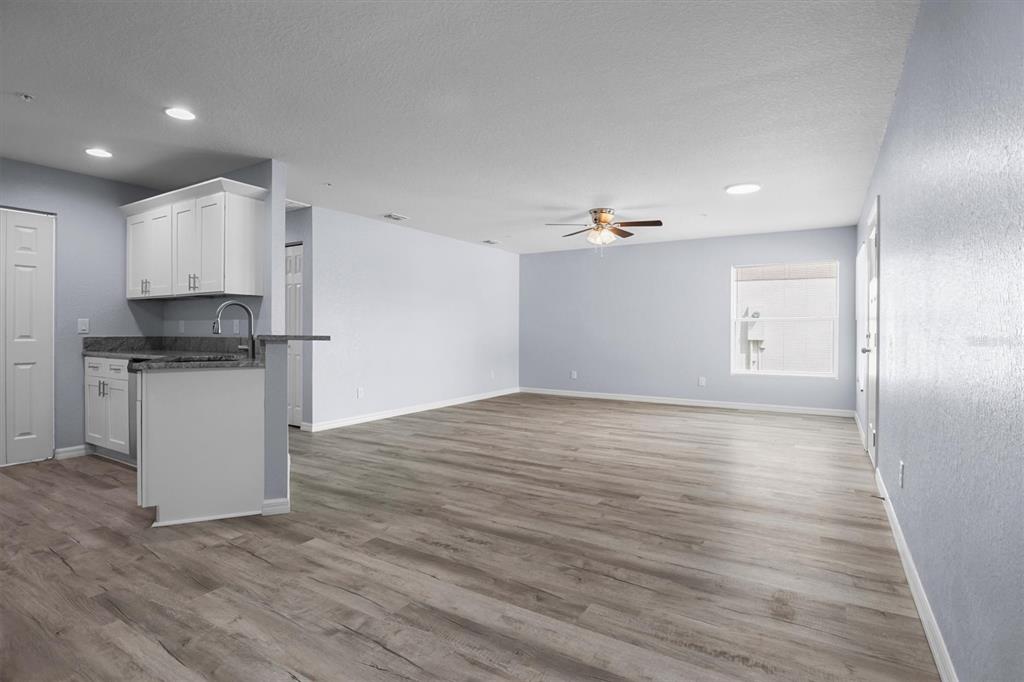 4078 Oak Loop Mulberry, FL 33860 - Photo 4 of 19 a view of a kitchen with a sink and dishwasher a refrigerator with wooden floor