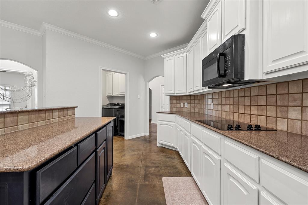 3696 Old Lorena Road Lorena, TX 76655 - Photo 13 of 27 Kitchen featuring white cabinetry, a built-in microwave, a flat-top electric range, and a tile backsplash