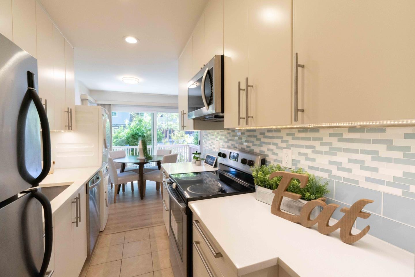 280 Easy Street, Unit 113 Mountain View, CA 94043 - Photo 2 of 22 a kitchen with sink refrigerator and stove