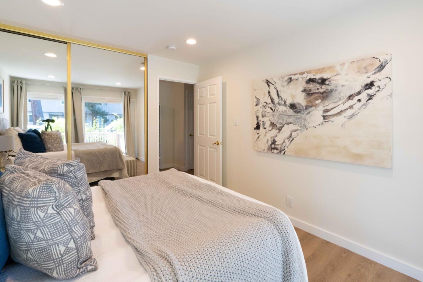 280 Easy Street, Unit 113 Mountain View, CA 94043 - Photo 10 of 22 a bedroom with a large bed and a painting on the wall