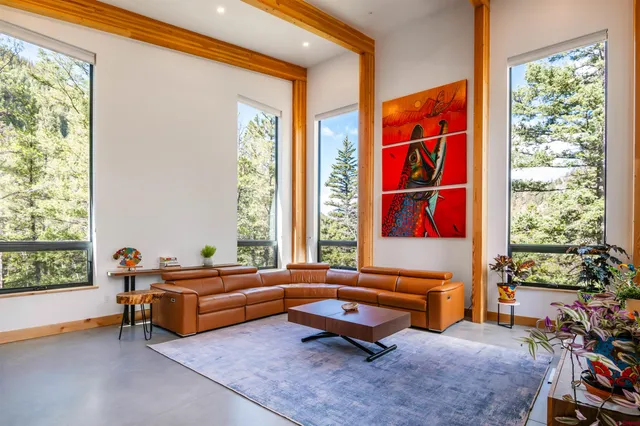 a room with pool table and windows