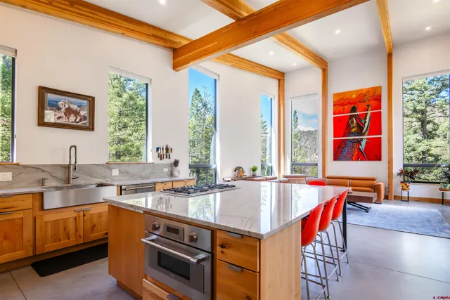 a kitchen with stainless steel appliances granite countertop a stove a sink and a refrigerator