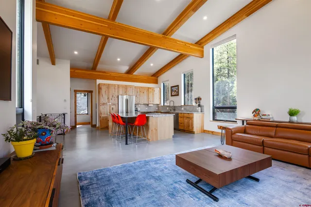 a living room with furniture a rug and white walls