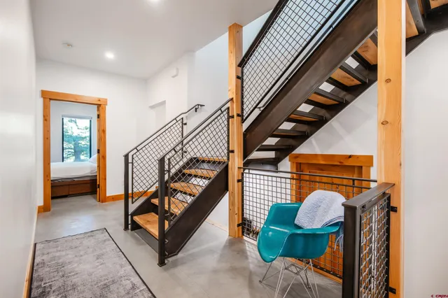 a view of an entryway with wooden floor and stairs