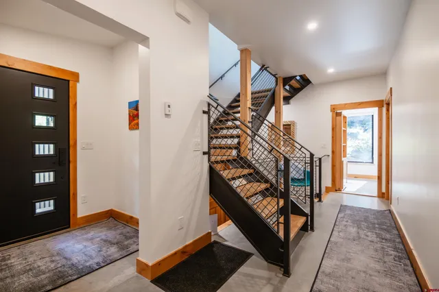 a view of an entryway wooden floor and stairs