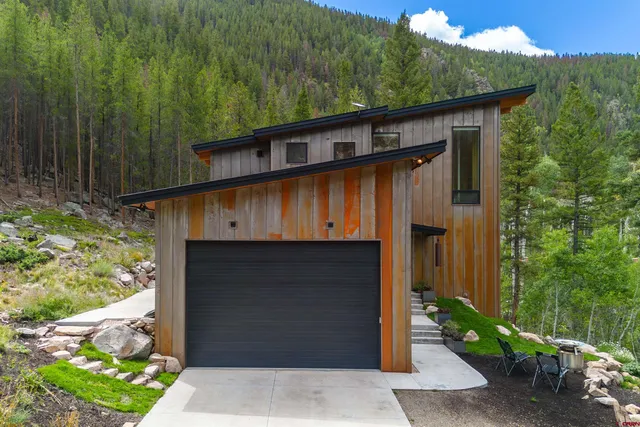a front view of house with green space