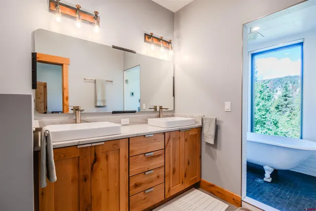 a bathroom with a double vanity sink and a mirror