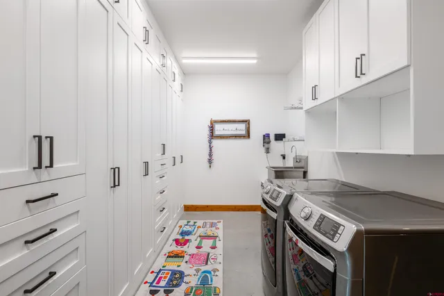 a kitchen with stainless steel appliances a stove a sink and a refrigerator