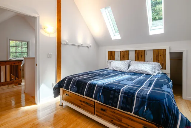 a bedroom with a bed next to a window