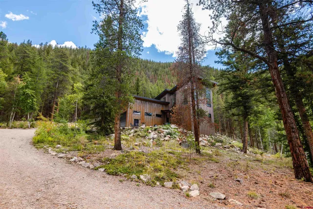 a view of a house with a tree in the background