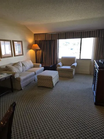 a bedroom with a bed and flat screen tv