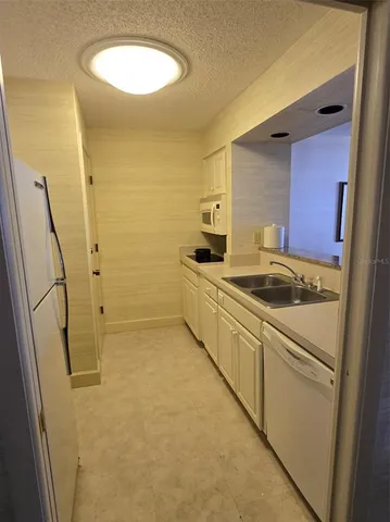 a living room with furniture and a air conditioner vent