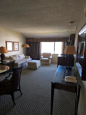 a dining room with furniture a rug and wooden floor