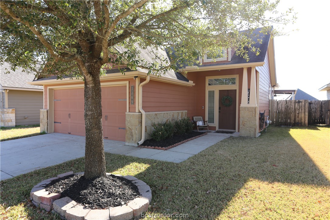 1069 Venice Drive Bryan, TX 77808 - Photo 1 of 1 a view of a backyard with plants and large tree