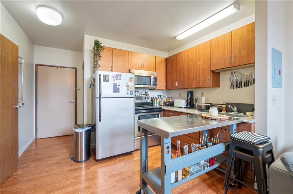 330 46th Street Pittsburgh, PA 15201 - Photo 12 of 25 a kitchen with stainless steel appliances granite countertop a refrigerator a stove a sink and a refrigerator