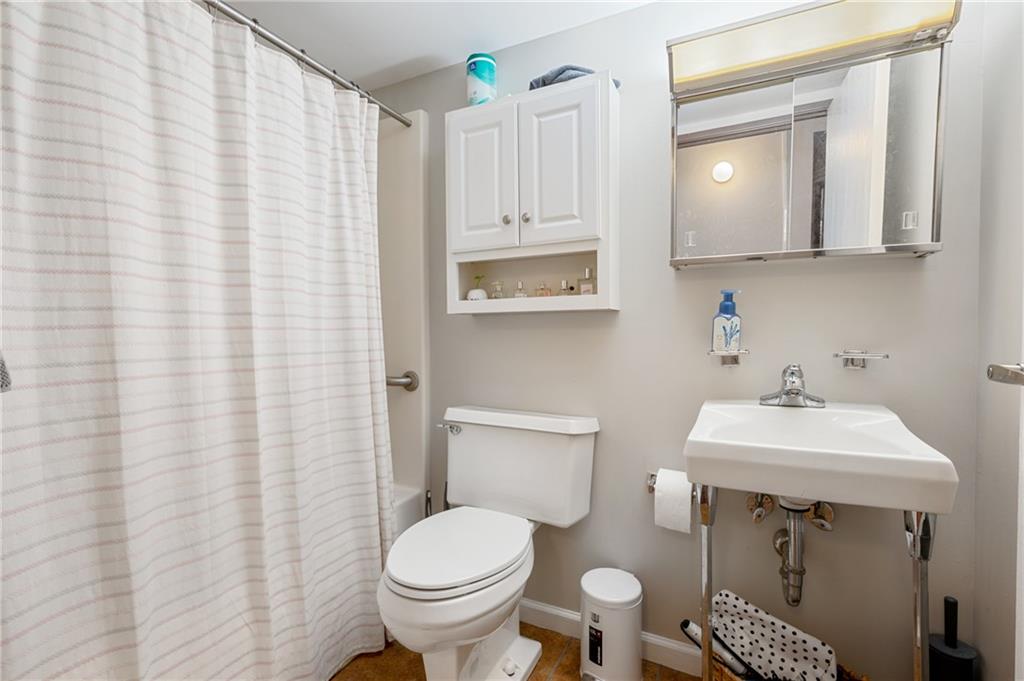 330 46th Street Pittsburgh, PA 15201 - Photo 15 of 25 a bathroom with a sink a toilet and a mirror