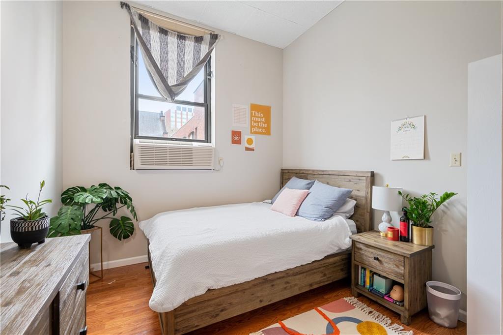 330 46th Street Pittsburgh, PA 15201 - Photo 16 of 25 a bedroom with a bed potted plant on the dresser and a window
