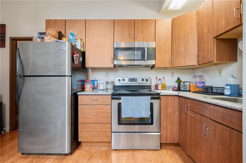 330 46th Street Pittsburgh, PA 15201 - Photo 5 of 25 a kitchen with stainless steel appliances granite countertop a refrigerator sink and stove