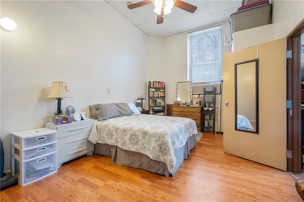 330 46th Street Pittsburgh, PA 15201 - Photo 8 of 25 a spacious bedroom with a bed and a chandelier