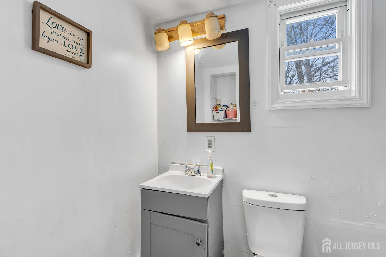 821 Front Street Dunellen, NJ 08812 - Photo 13 of 17 a bathroom with a toilet sink and mirror