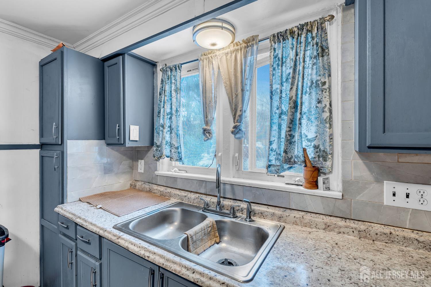 821 Front Street Dunellen, NJ 08812 - Photo 6 of 17 a kitchen with a sink and a large mirror
