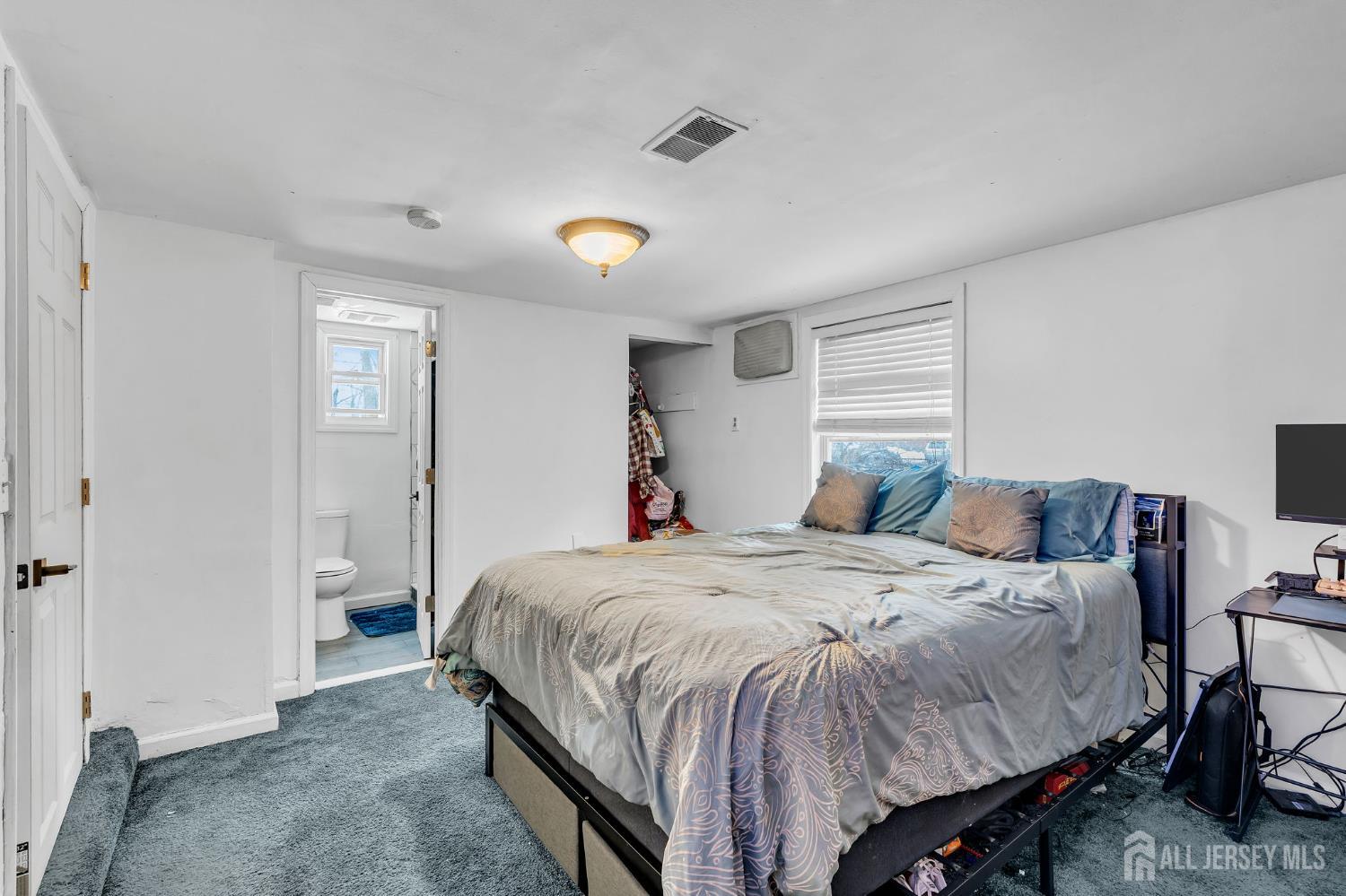 821 Front Street Dunellen, NJ 08812 - Photo 9 of 17 a bedroom with a bed and a table
