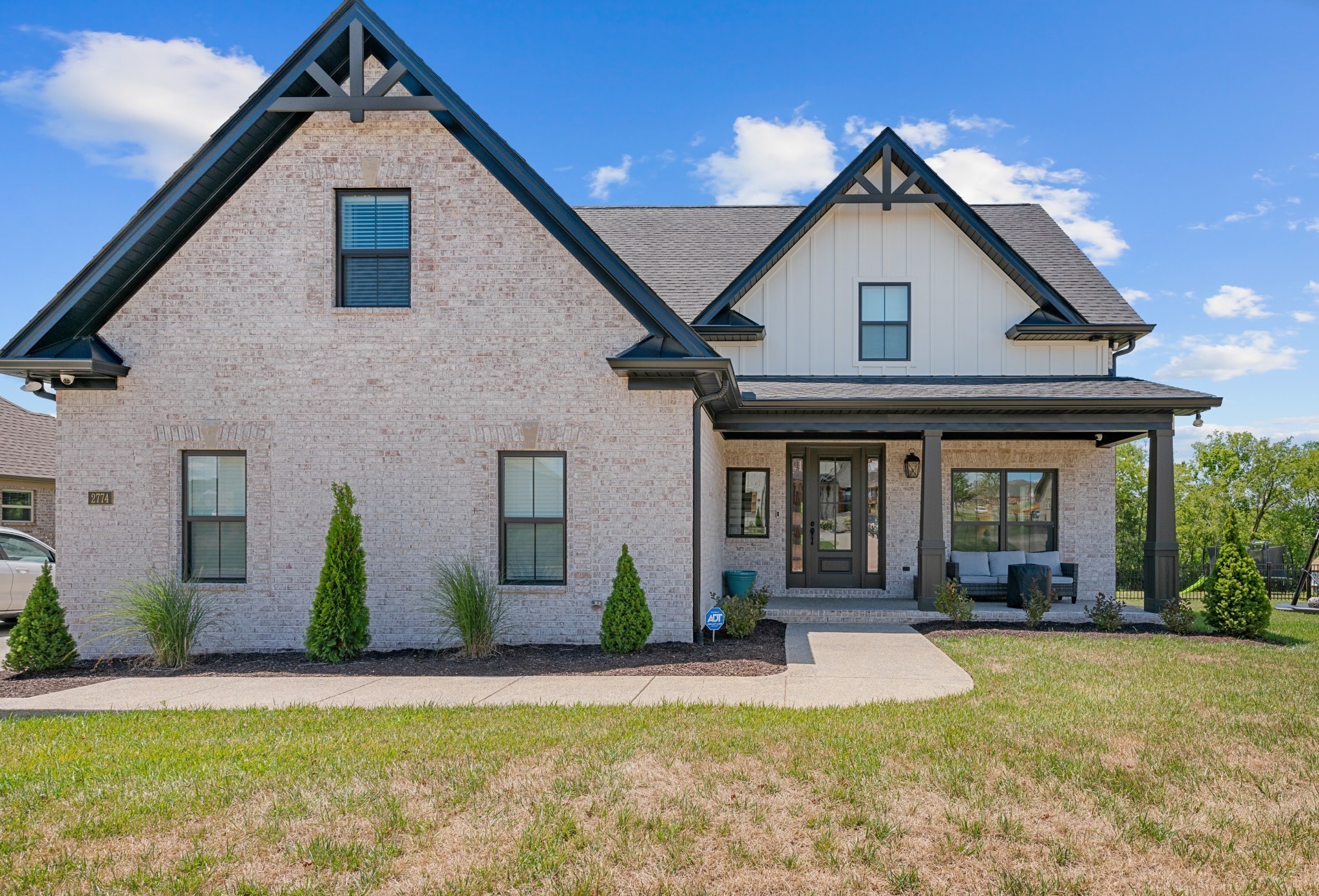 2774 Jasmine Street Lebanon, TN 37087 - Photo 2 of 47 a view of a house with potted plants and a large tree