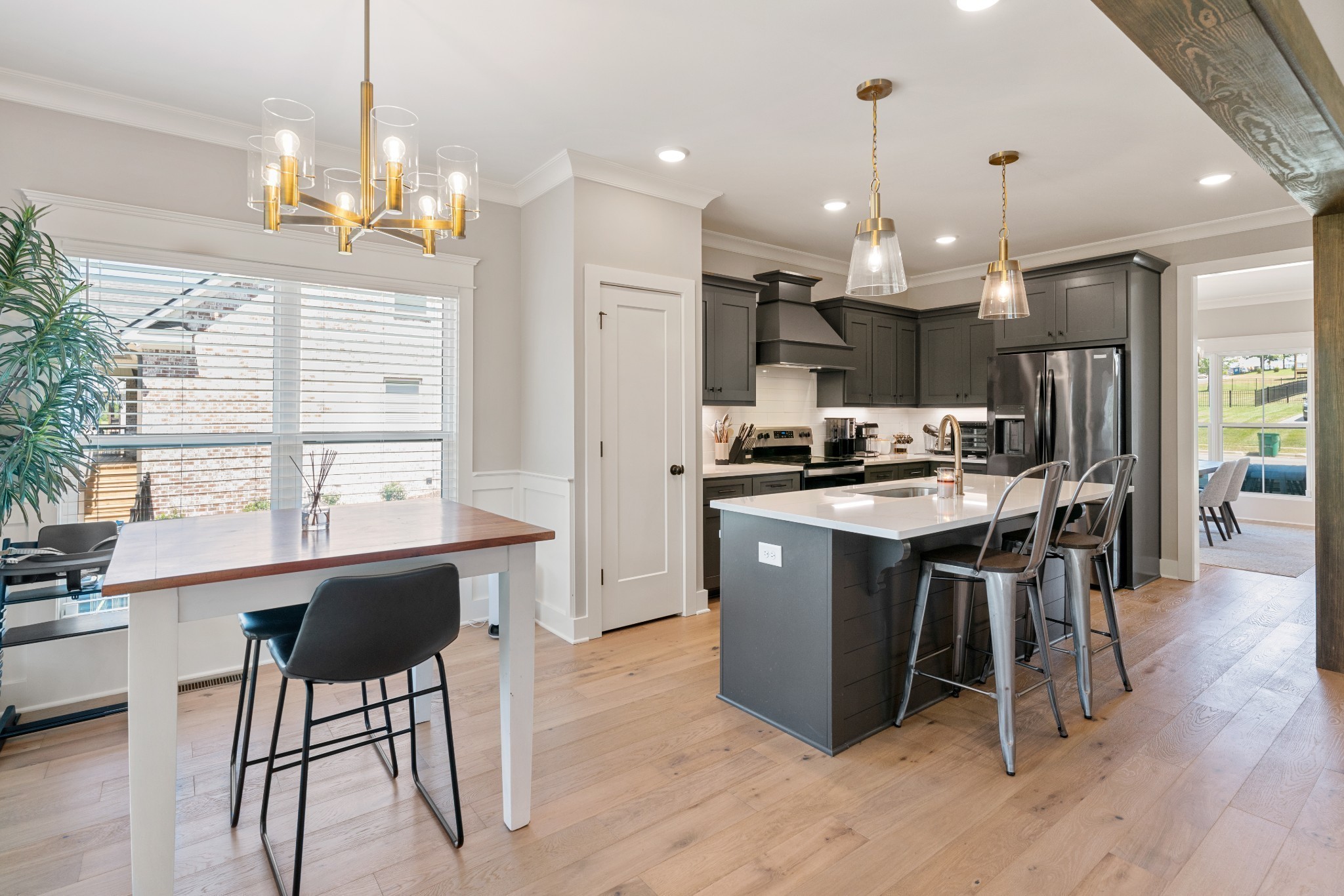 2774 Jasmine Street Lebanon, TN 37087 - Photo 10 of 47 a kitchen with kitchen island a dining table chairs and a wooden floor
