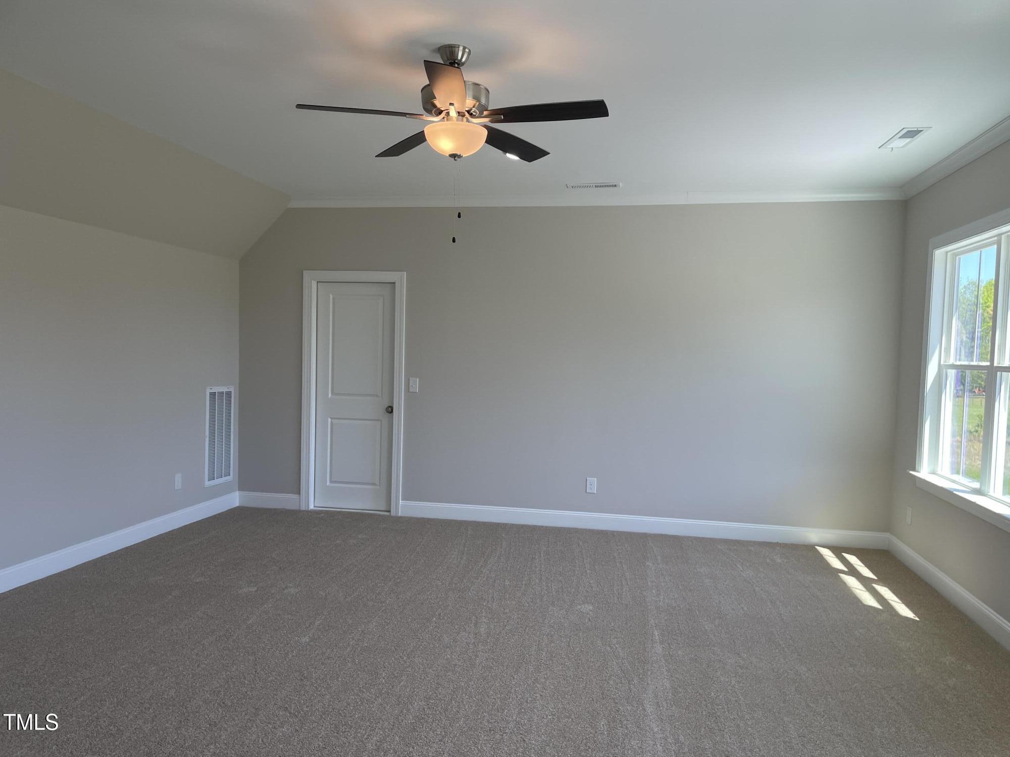 85 Old Gdn Lane Youngsville, NC 27596 - Photo 14 of 17 an empty room with a window and a fan