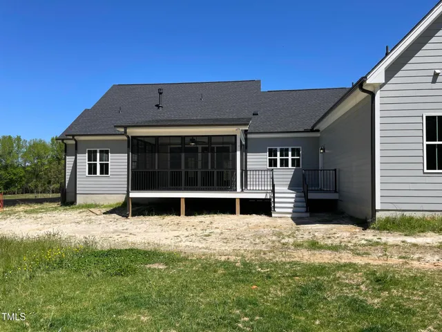 a view of a deck with wooden floor and fence next to a yard