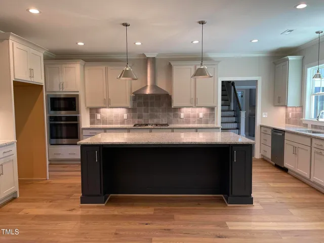 a kitchen with granite countertop a stove sink and cabinets