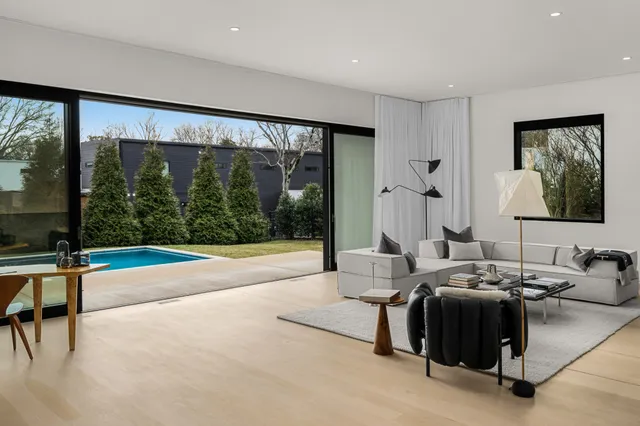 a living room with furniture and large windows