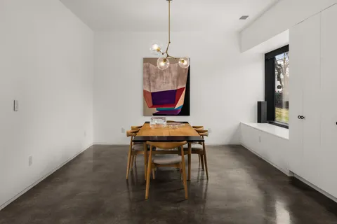 a view of a room with a table and chairs