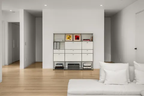 a living room with a couch and a table with wooden floor