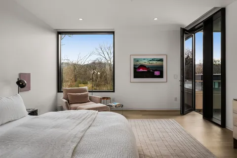 a bedroom with furniture and a flat screen tv