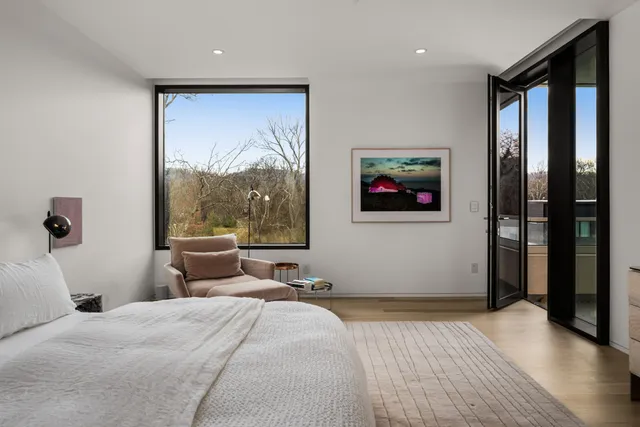 a bedroom with furniture and a flat screen tv