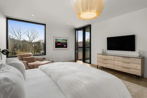 a bathroom with a sink mirror and toilet