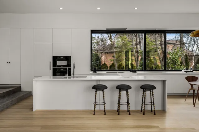 a view of a kitchen with a sink and a large window