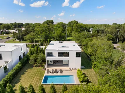 an aerial view of a house with a yard