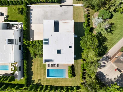 an aerial view of residential houses with outdoor space and street view