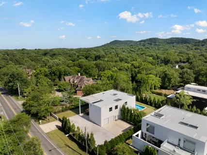 a front view of a house with swimming pool having outdoor seating