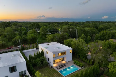 a view of a house with swimming pool and sitting area