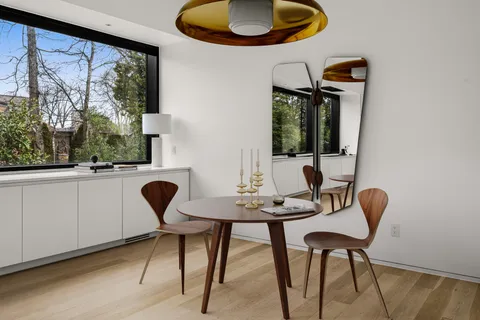 a view of a dining room with furniture and window