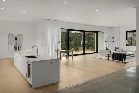 a living room with furniture and large windows