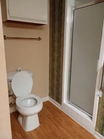 a white toilet sitting next to a bathroom sink
