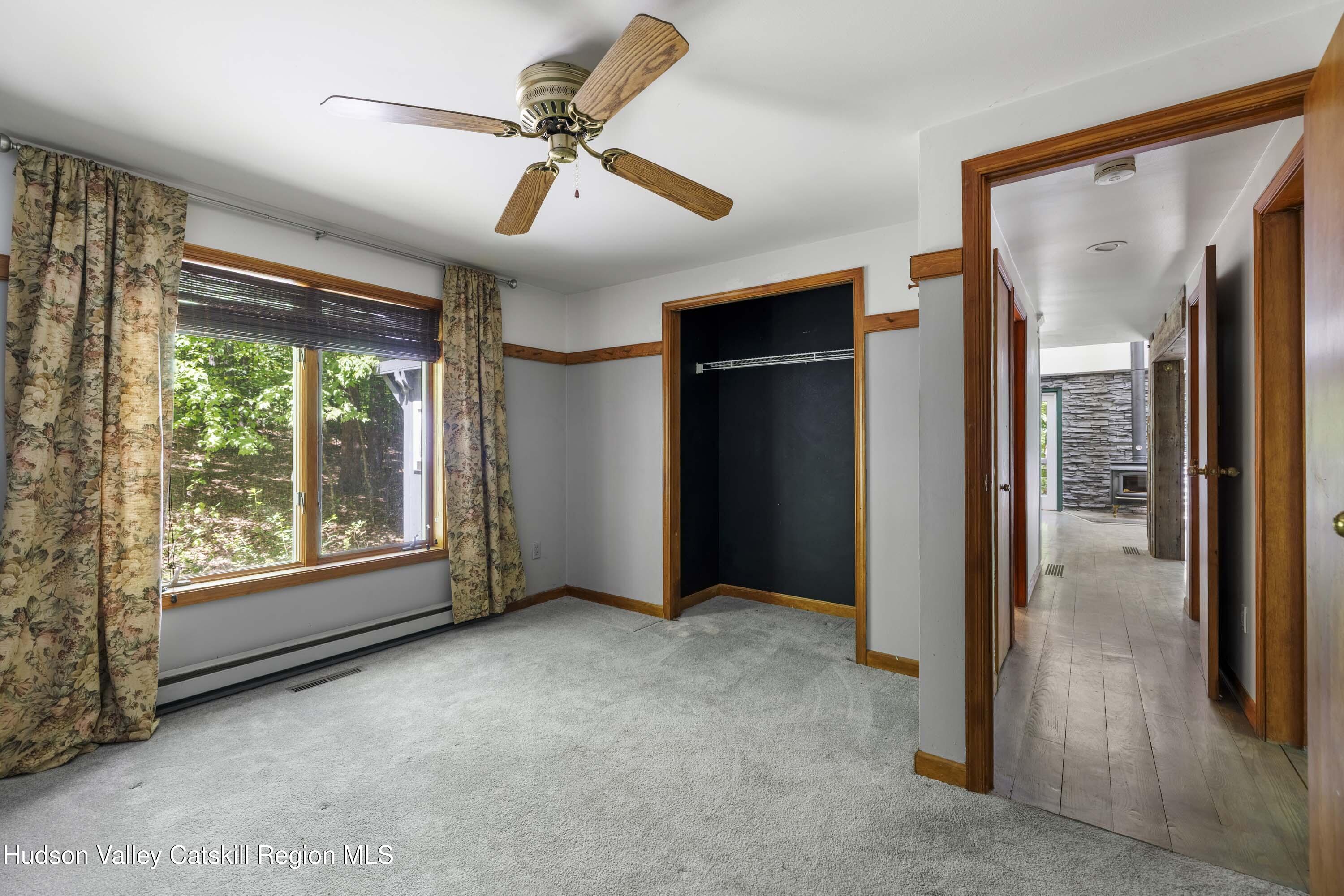 126 Storks Nest Road Round Top, NY 12473 - Photo 34 of 62 an empty room with windows and closet