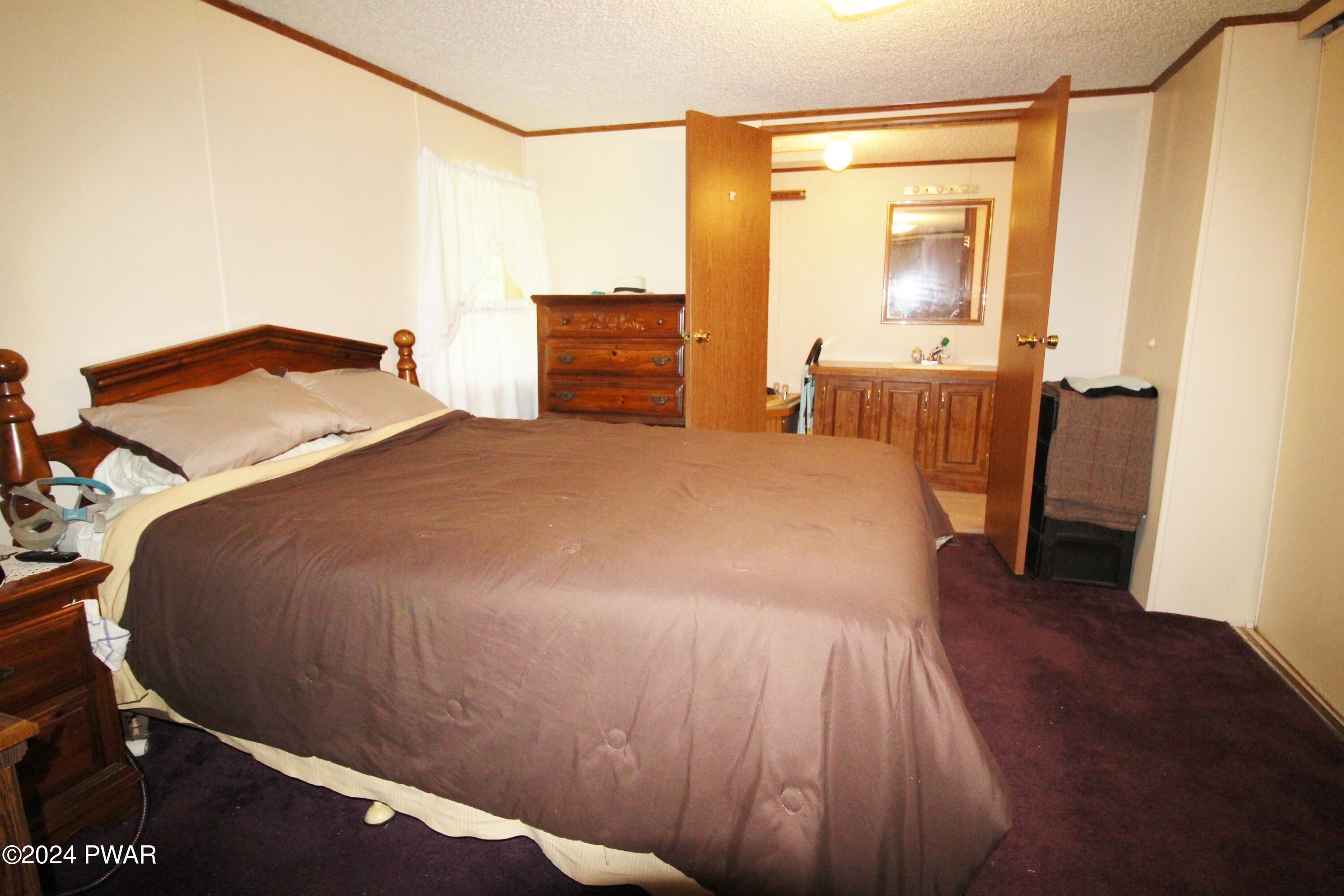10 Madison Estate Moscow, PA 18444 - Photo 24 of 45 a bedroom with a bed and wooden floor