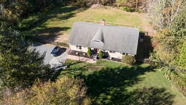 an aerial view of a house with yard swimming pool and outdoor seating