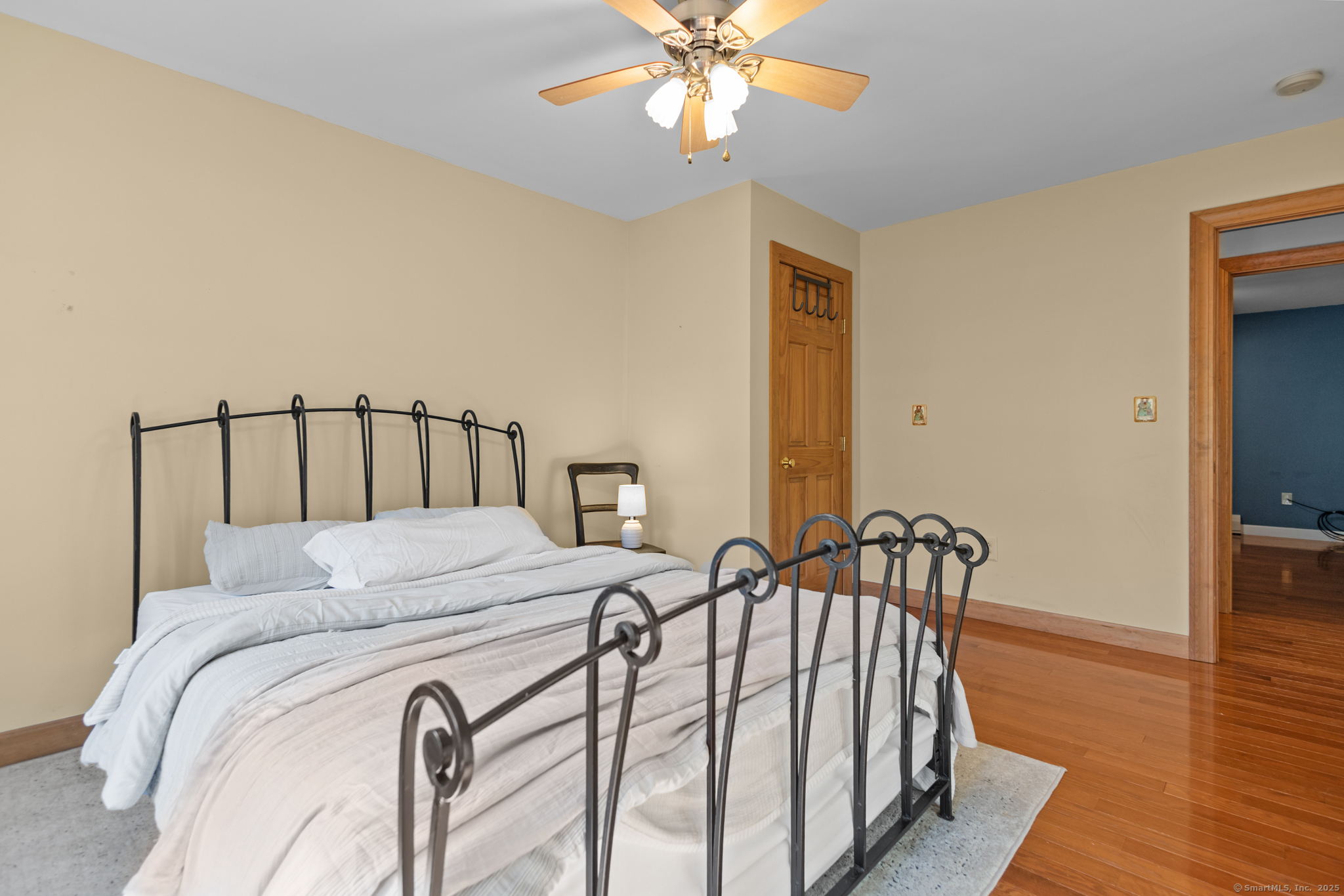 679 Bailey Hill Road Killingly, CT 06241 - Photo 23 of 39 a bedroom with a bed and wooden floor