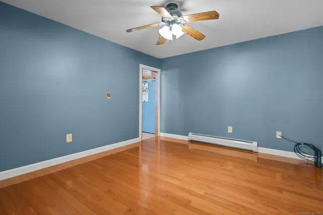 wooden floor in an empty room with a window
